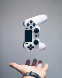 Game controller hovering above person's hand